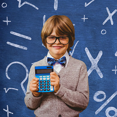 Schoolboy holding calculator in front of a chalkboard